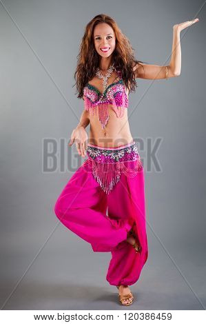 Girl In Pink Orient Dance Costume Poses On Leg