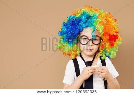 Close-up Portrait Of Little Boy In Clown Wig And Eyeglasses