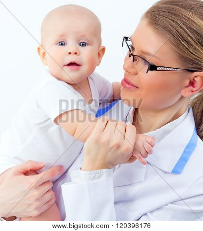 Pretty doctor pediatrician holding hand of sweet infant