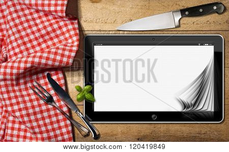 Tablet And Cutlery On A Table With Tablecloth