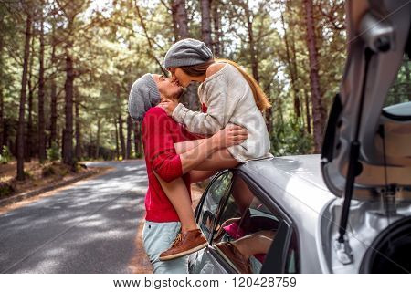Young couple traveling by car in the forest
