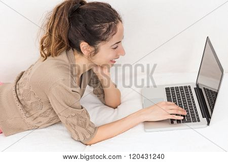 Woman With Her Laptop On The Couch