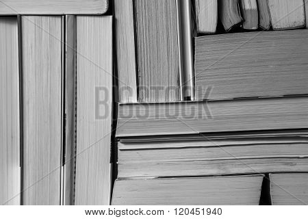 Stack of used old books on bookshelf