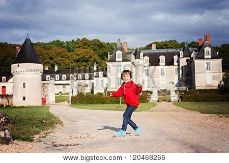 Two Boys, Happily Playing After The Rain On The Driveway Of French Gizeux Castle