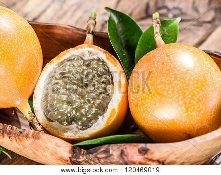 Granadilla fruits on the wooden table.