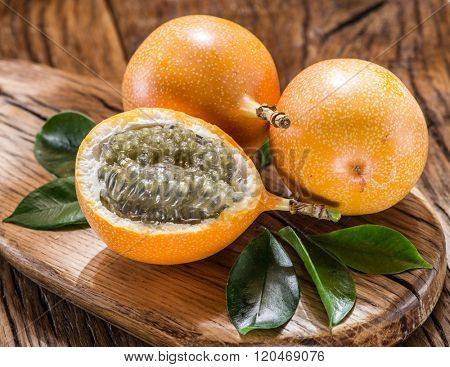 Granadilla fruits on the wooden table.