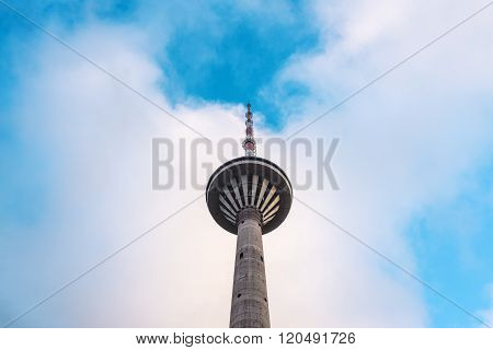 Television transmission tower in Tallinn, Estonia, against a blue sky