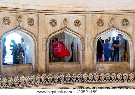 People looking through arches at charminar hyderabad
