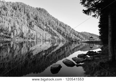 Mountain panorama from Italian Alps. Reflections on water from 