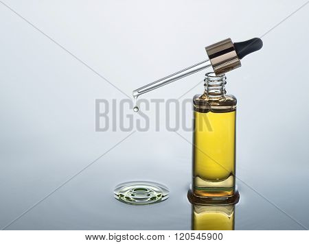 Moisturizing cosmetic oil stands on the dark water background with splash