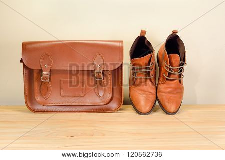 Still Life With Brown Leather Shoes With Leather Bag On Wooden Table