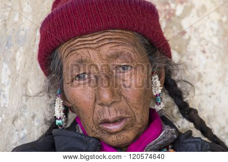 LAMAYURU INDIA - JUNE 15 2015: Unidentified buddhist old woman during mystical mask dancing Tsam mystery dance in time of Yuru Kabgyat Buddhist festival at Lamayuru Gompa Ladakh North India