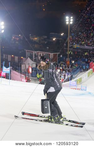 STOCKHOLM SWEDEN - FEB 23 2016: Official woman with a scoop and audience in the background at the Audis FIS Alpine Ski World Cup city event February 23 2016 Stockholm Sweden