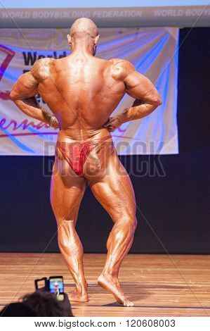 Male Bodybuilder Flexes His Muscles To Show His Physique