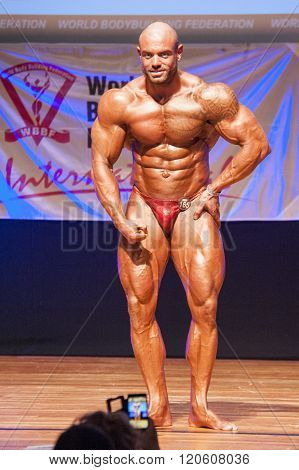 Male Bodybuilder Flexes His Muscles To Show His Physique
