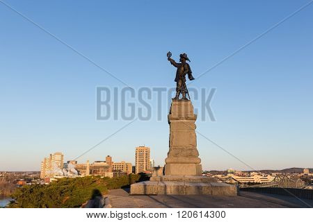 Statue of Jacques Cartier against a blue sky in spring