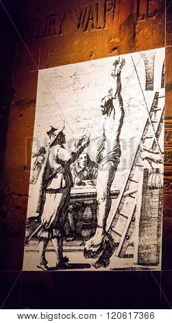 LONDON UK - JUNE 6 2015: Copy of the ancient painting of torture on reared in the basement of the tower Wakefield at Tower of London. The Wakefield Tower was built by King Henry III between 1238 - 1272
