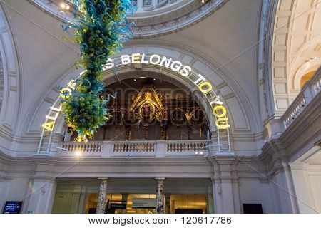 LONDON UNITED KINGDOM - JUNE 6 2015: Interior of the Victoria and Albert Museum lobby with Dale Chihuly glass chandelier. V&A Museum is the world's largest museum of decorative arts and design.