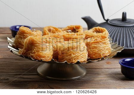 Eastern Sweets Surrounded Teapot And Two Bowls