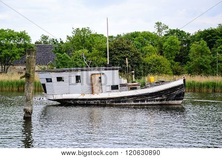 Black And White House Boat Anchor On The Canal In Copenhagen At Summertime