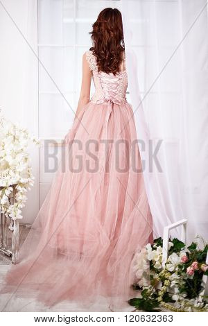 Bride in a pink dress with flowers