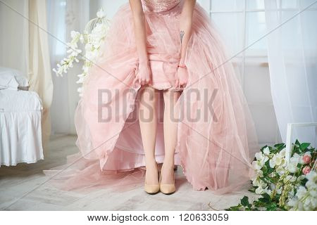 Bride in a pink dress with flowers