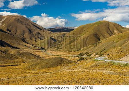 Road in Lindis Pass beautifully lit by the evening sun. Otago region, New Zealand