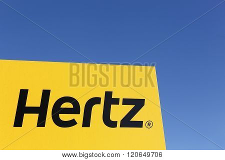 Aarhus, Denmark - February 13, 2016: Hertz logo on a panel. Hertz is an American car rental company with international locations in 145 countries worldwide.