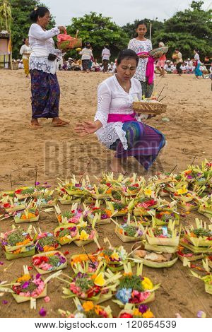 SANUR, BALI - MAR 18, 2016: Unidentified local people during ceremony Melasti Ritual. Melasti is a Hindu Balinese purification ceremony and one of the most important rituals of Bali island. 