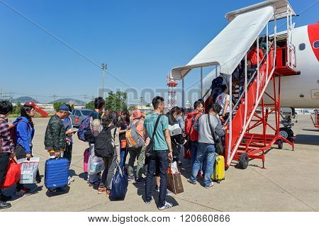 PATTAYA, THAILAND - FEBRUARY 26, 2016: people boarding Thai AirAsia A320 at U-Tapao International Airport. U-Tapao Rayong -Pattaya International Airport is serving Rayong and Pattaya cities
