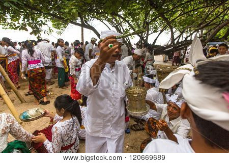 SANUR, BALI - MAR 18, 2016: Unidentified local people during performed Melasti Ritual. Melasti is a Hindu Balinese purification ceremony and ritual is held several days prior to the Nyepi holy day.