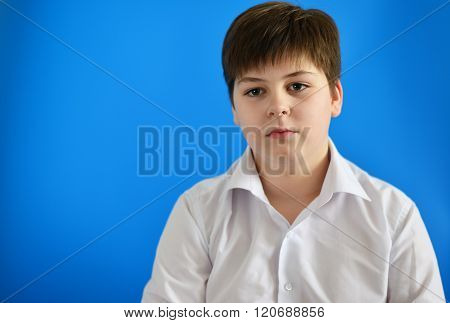 Portrait of teenage boy on the blue background
