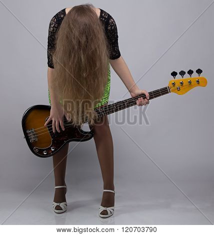Teenage girl with guitar, headbang