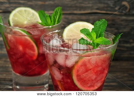 Closeup Red Cocktail With Mint, Lime And Ice