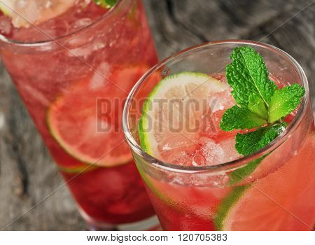 Close-up Red Cocktail With Ice, Lime And Mint