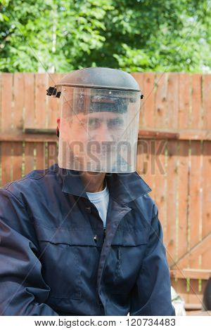 Young Man In A Scullguard On Building
