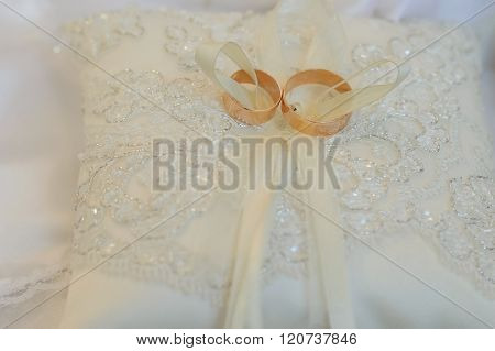 Wedding rings on white  pillow.