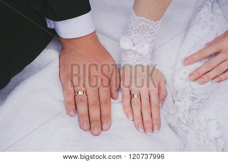 Bride and groom's hands with wedding rings