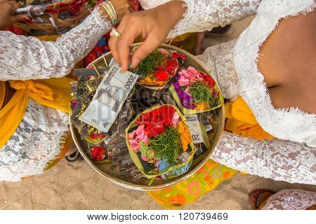 SANUR, BALI - MAR 18, 2016: Unidentified local people during Melasti Ritual. Melasti is a Hindu Balinese purification ceremony and ritual is held several days prior to the Nyepi holy day.