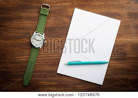 Notepad and watches on the desk