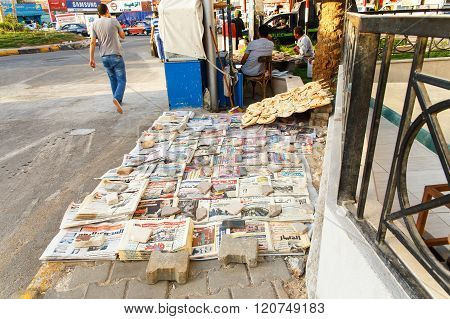 Newspapers And Bread In The Street.