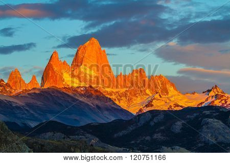 Blood-red sunset illuminates the top of impressive cliffs Fitz Roy. Fantastic Patagonia