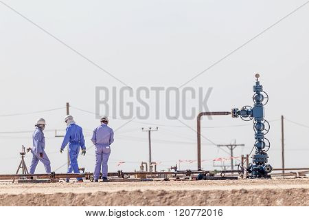 Workers At A Borehole