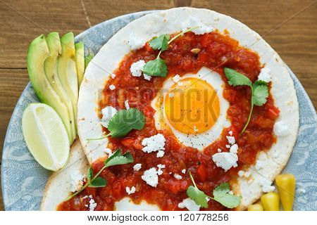 Mexican Breakfast Huevos Rancheros: Fried Egg With Salsa Closeup In The Pan