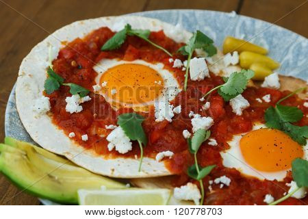 Breakfast with fried egg and sauce on grilled tortilla, Mexicanhuevos rancheros