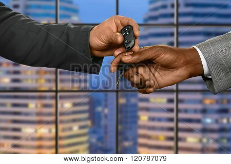 Clerk gives car key.