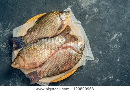 Three Fresh Carp On Wooden Board, Top View, With Copy Space