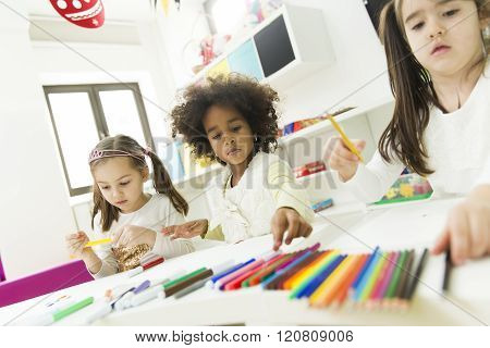 Multiracial Children Drawing In The Playroom