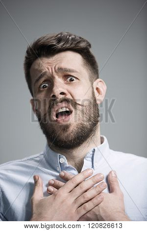 Man is looking imploring over gray background