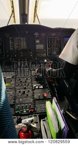 Pilot and copilot in corporate plane in cockpit, Pilot operation with control panel.